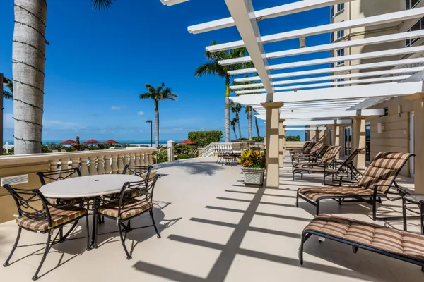 a view of a patio with a table and chairs