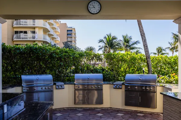 a backyard of a house with barbeque oven and stove