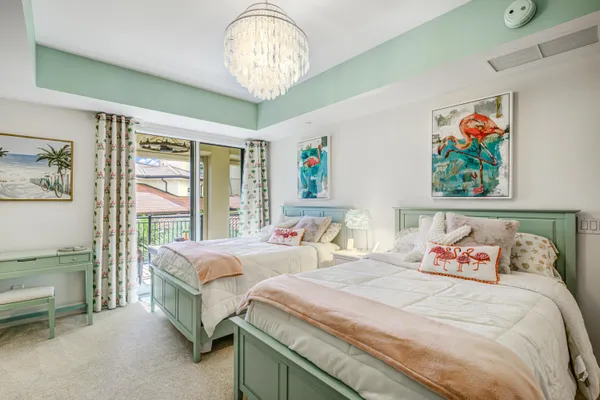 a bedroom with bed and a large window