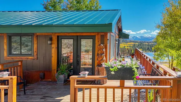 a front view of house with outdoor seating and wooden floor