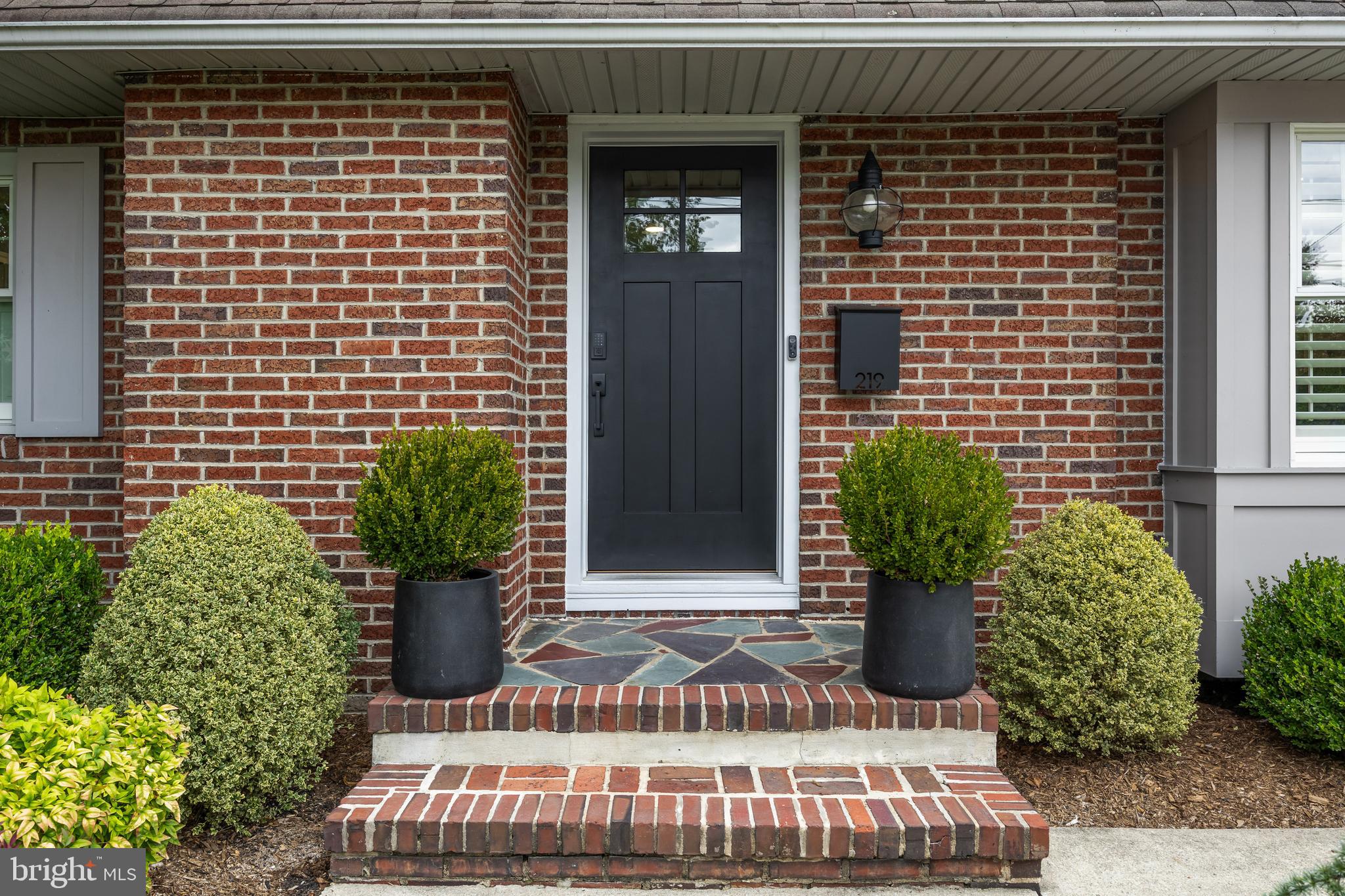 219 West Summit Avenue Haddonfield, NJ 08033 - Photo 2 of 29 a view of brick house with potted plants