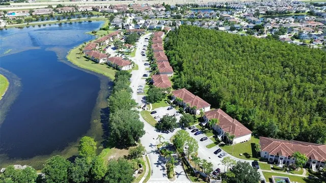 an aerial view of a house with a garden and lake view