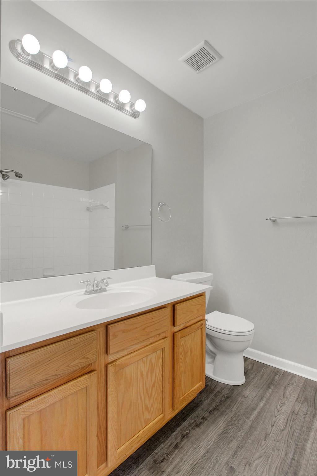 46 Forest View Terrace Hanover, PA 17331 - Photo 20 of 28 a bathroom with a granite countertop sink a toilet and a mirror
