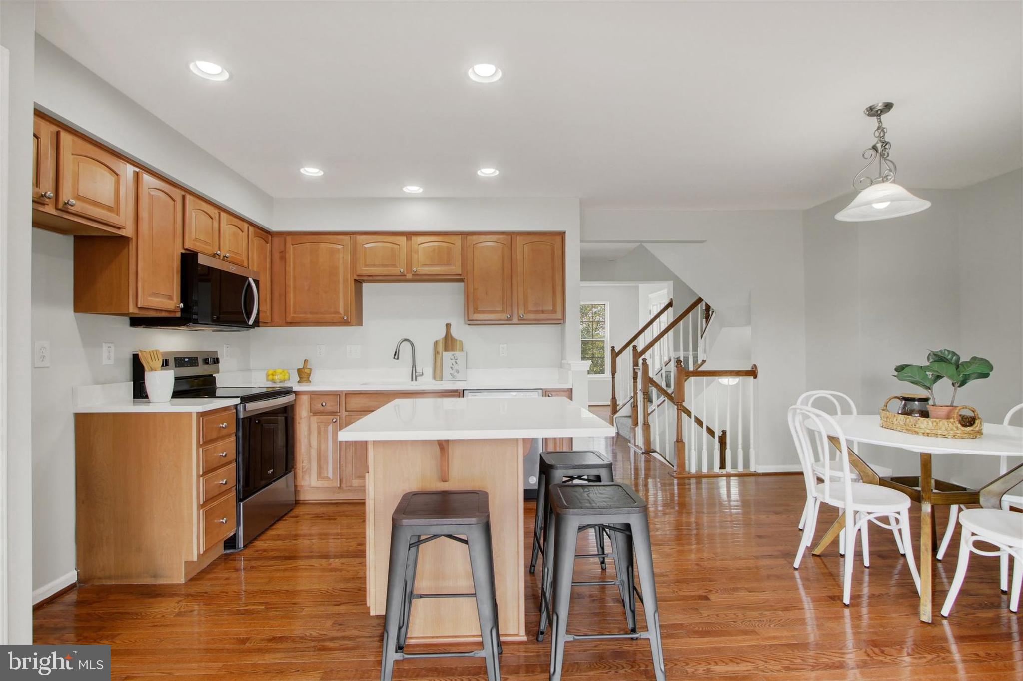 46 Forest View Terrace Hanover, PA 17331 - Photo 10 of 28 a kitchen with stainless steel appliances kitchen island granite countertop a refrigerator a stove top oven a sink dishwasher and white cabinets with wooden floor