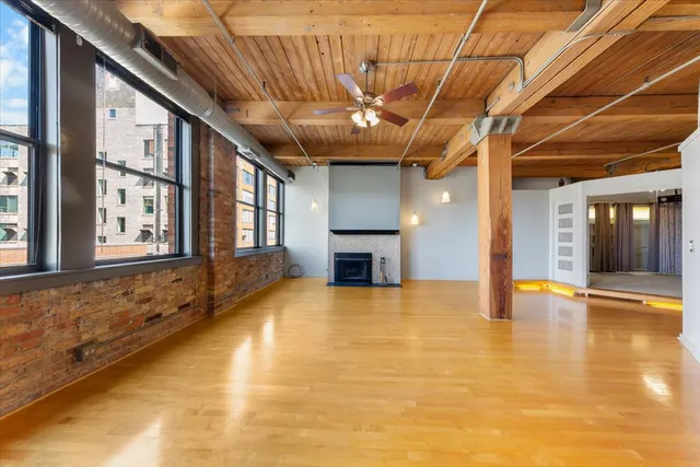 a kitchen with stainless steel appliances granite countertop a sink a stove a refrigerator with grey cabinets