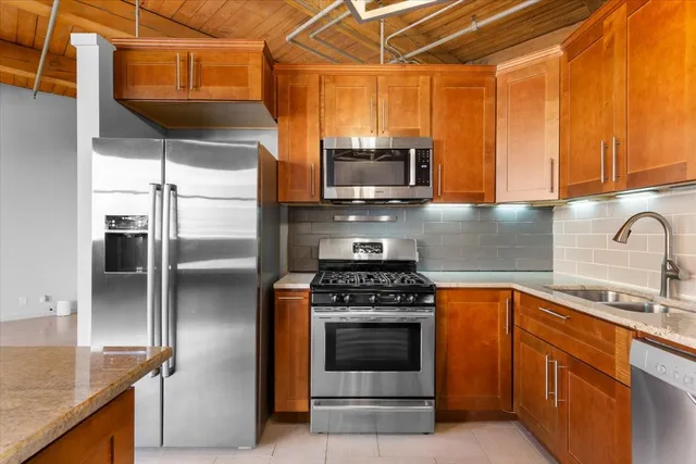 a view of a kitchen with wooden floor and sink