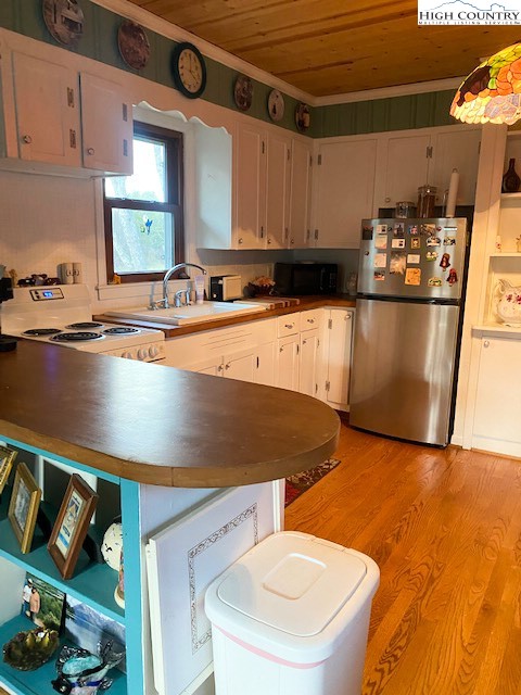 273 Walnut Branch Church Road Sparta, NC 28675 - Photo 18 of 41 a kitchen with stainless steel appliances granite countertop a sink a stove and white cabinets