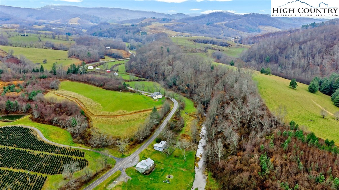 273 Walnut Branch Church Road Sparta, NC 28675 - Photo 28 of 41 a view of a lush green hillside and a houses