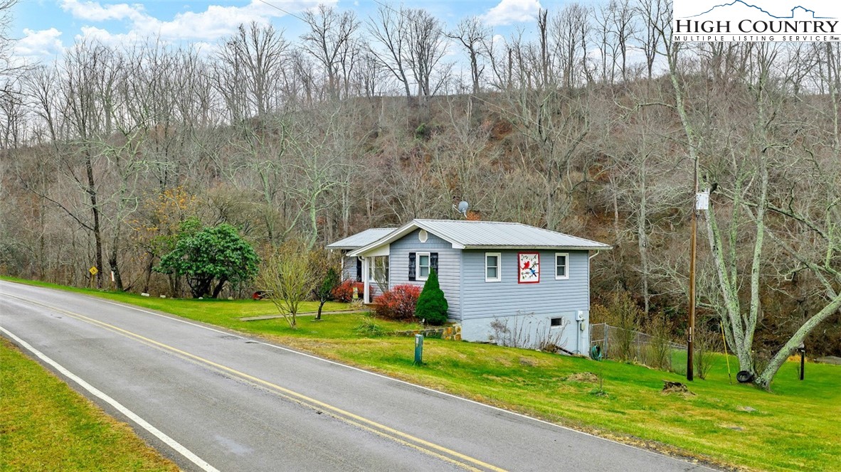 273 Walnut Branch Church Road Sparta, NC 28675 - Photo 3 of 41 a front view of a house with garden