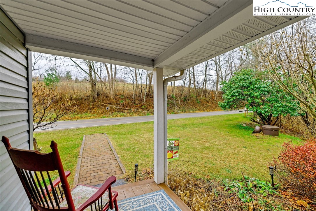 273 Walnut Branch Church Road Sparta, NC 28675 - Photo 32 of 41 a view of a two chairs in the patio next to a yard