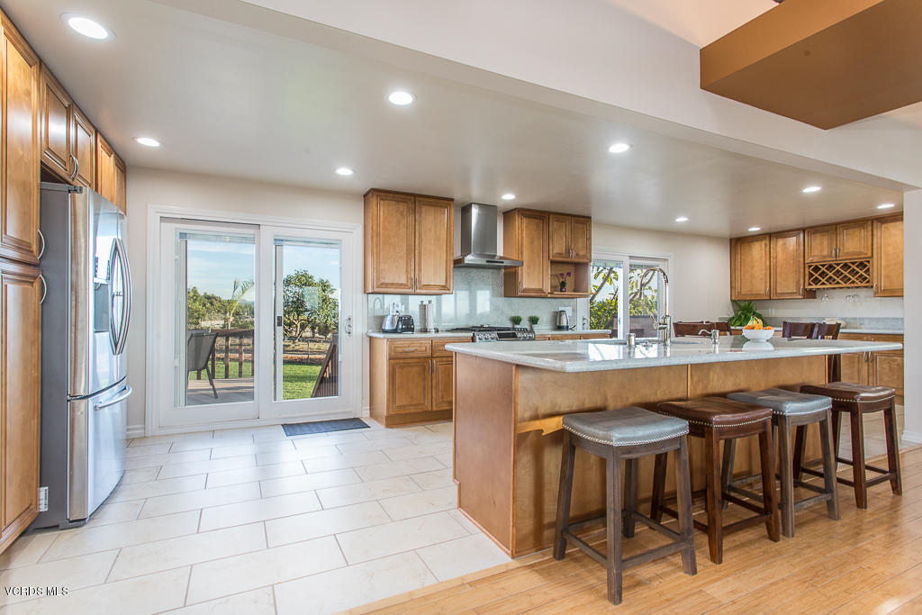 3774 Groves Place Somis, CA 93066 - Photo 5 of 51 a kitchen with stainless steel appliances granite countertop a stove a sink a refrigerator and a dining table with wooden floor