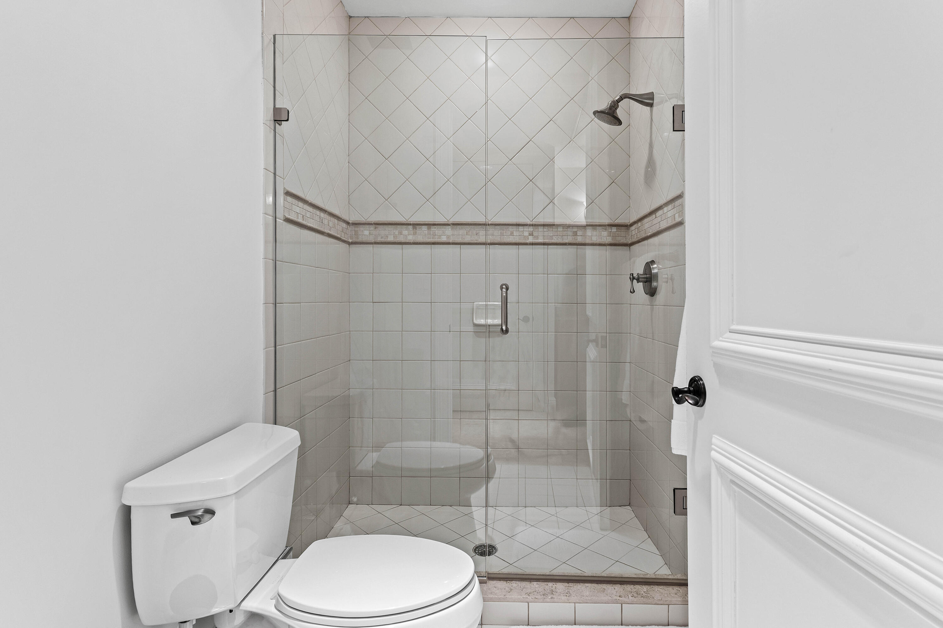 110 Gleason Street, Unit 203 Delray Beach, FL 33483 - Photo 12 of 25 a bathroom with a toilet and shower
