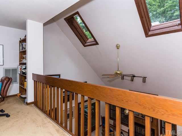 1212 Stone Creek Way Raleigh, NC 27615 - Photo 14 of 25 The loft overlooks the 2 story living room and offers shelving ideal for a library space or office space.