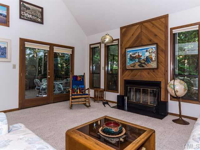 1212 Stone Creek Way Raleigh, NC 27615 - Photo 3 of 25 The living room steps down from the foyer and offers a striking fireplace with quality woodwork from floor to ceiling.