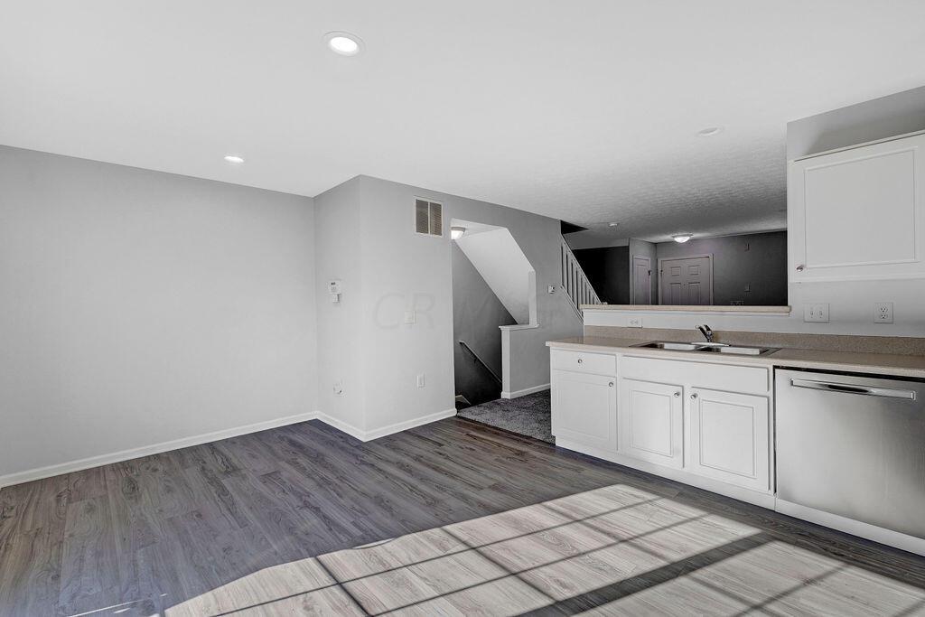 6345 Needletail Road, Unit 24634 Columbus, OH 43230 - Photo 11 of 58 • New luxury vinyl plank flooring ~ 2021 • Gray painted walls • Can lighting