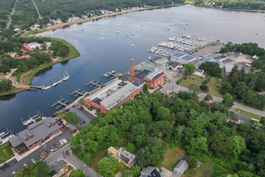 45 Main Street, Unit 112 Wareham, MA 02571 - Photo 29 of 30 an aerial view of a house with a yard and lake view