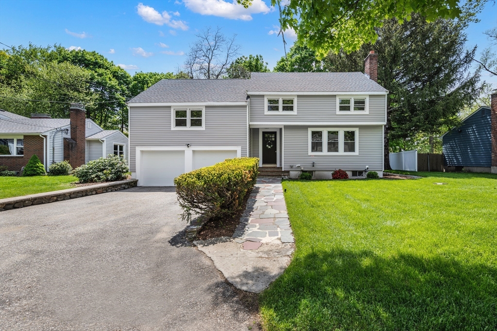 a front view of house with yard and green space