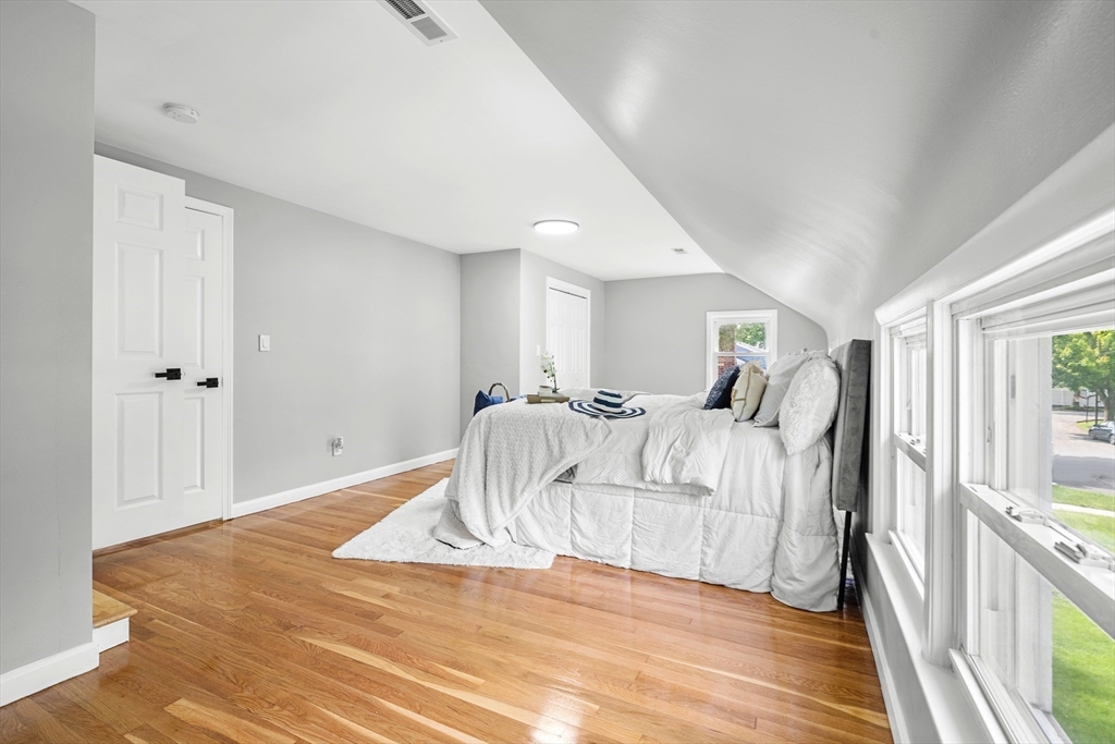 102 Hathaway Circle Arlington, MA 02476 - Photo 13 of 38 a bed room with a bed and a large window