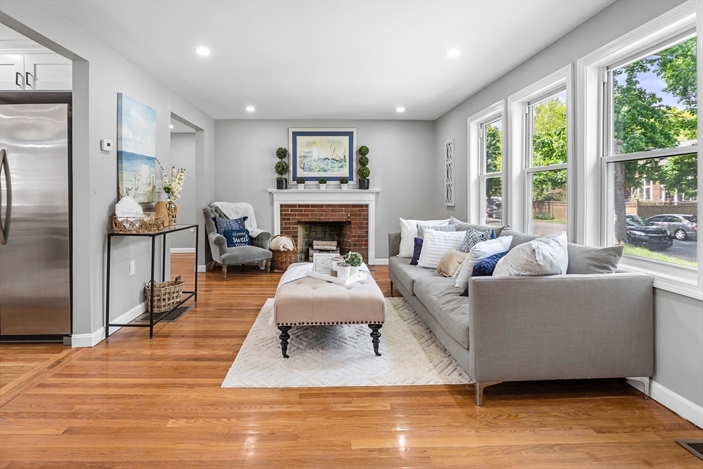 102 Hathaway Circle Arlington, MA 02476 - Photo 25 of 38 a living room with furniture and a fireplace