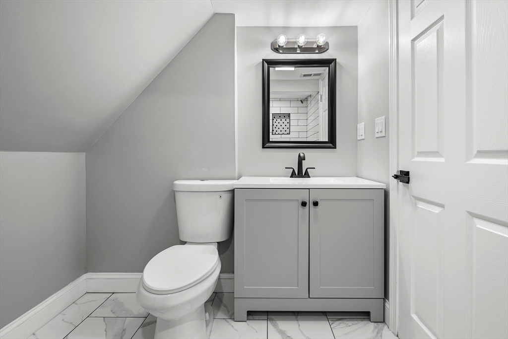 102 Hathaway Circle Arlington, MA 02476 - Photo 30 of 38 a bathroom with a toilet sink and mirror