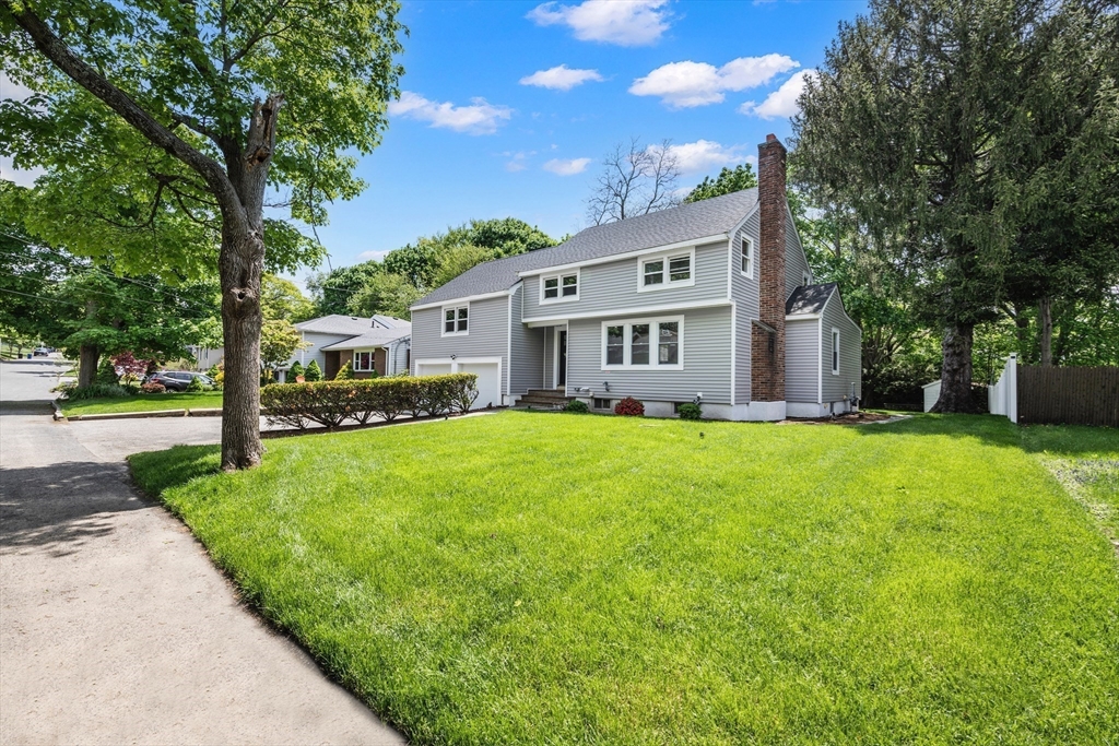 102 Hathaway Circle Arlington, MA 02476 - Photo 4 of 38 a front view of a house with a yard table and trees