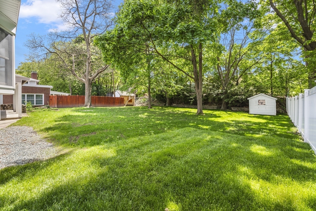 102 Hathaway Circle Arlington, MA 02476 - Photo 7 of 38 a view of a backyard with a small cabin