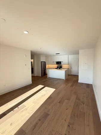 a view of a kitchen with a sink and a refrigerator