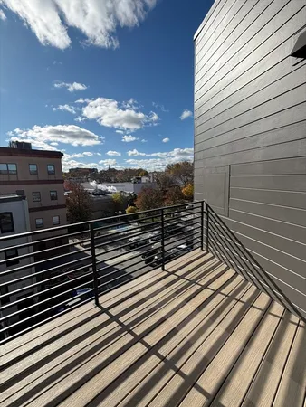a view of a balcony with two chairs