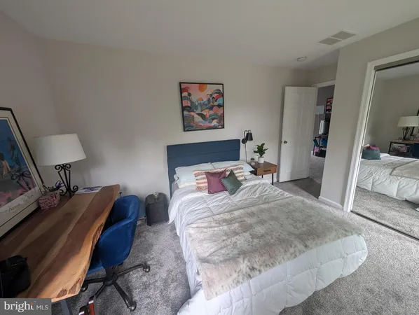 a view of a livingroom with wooden floor and a flat screen tv