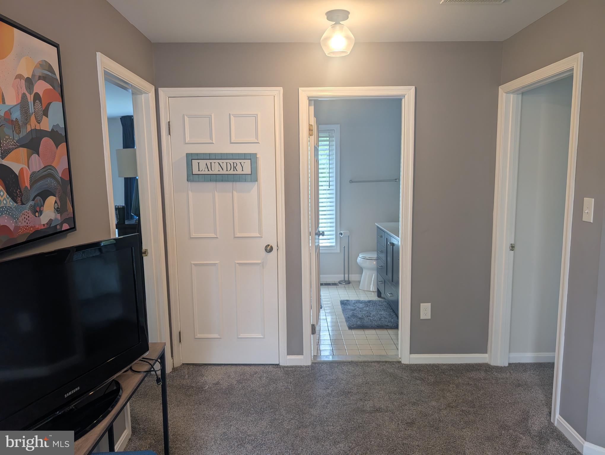 3002 Courtside Road Bowie, MD 20721 - Photo 33 of 48 a view of a livingroom with wooden floor and a flat screen tv