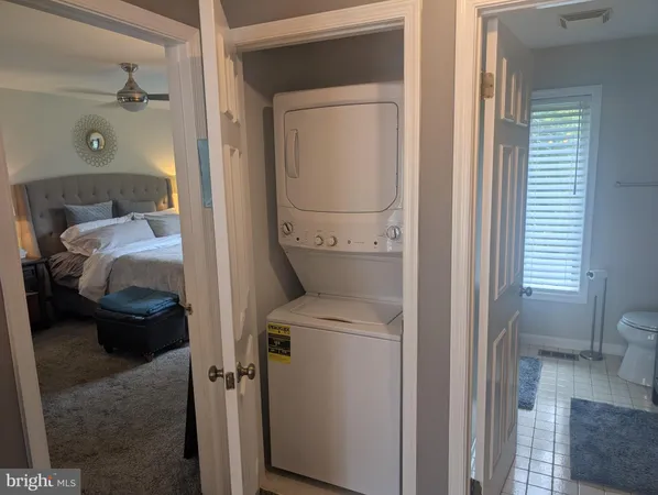 a bedroom with a bed a couch and dresser