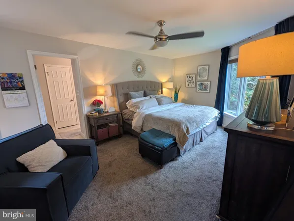 a bedroom with a bed and a television