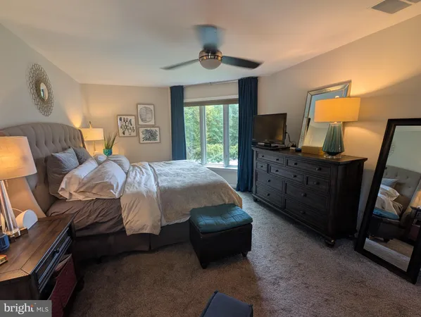 a bedroom with a bed and a mirror