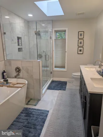 a bathroom with a shower a toilet and sink