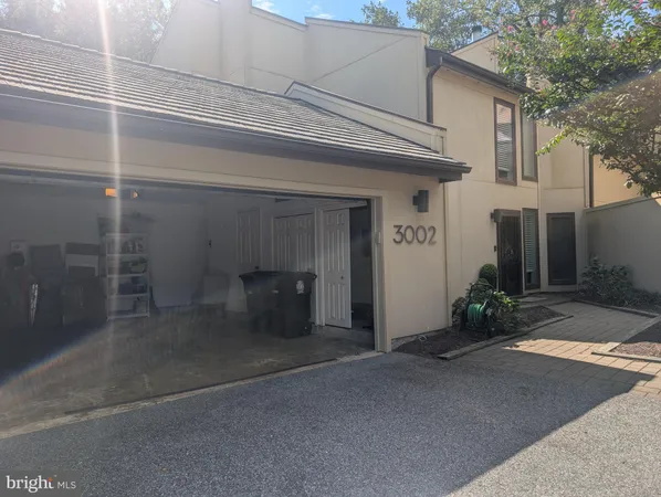 a view of a house with a big yard and large trees