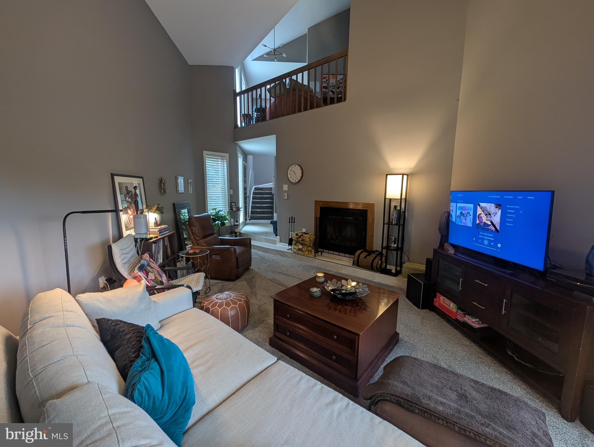 3002 Courtside Road Bowie, MD 20721 - Photo 8 of 48 a living room with furniture a flat screen tv and a fireplace