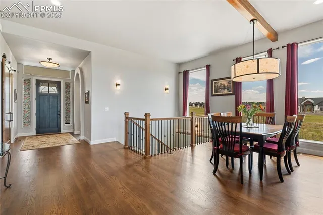 a view of a dining room with furniture window and wooden floor