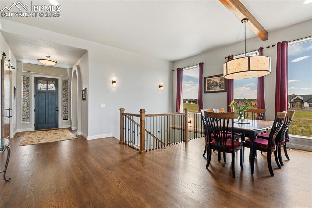 11726 Rambling Road Colorado Springs, CO 80908 - Photo 11 of 50 a view of a dining room with furniture window and wooden floor