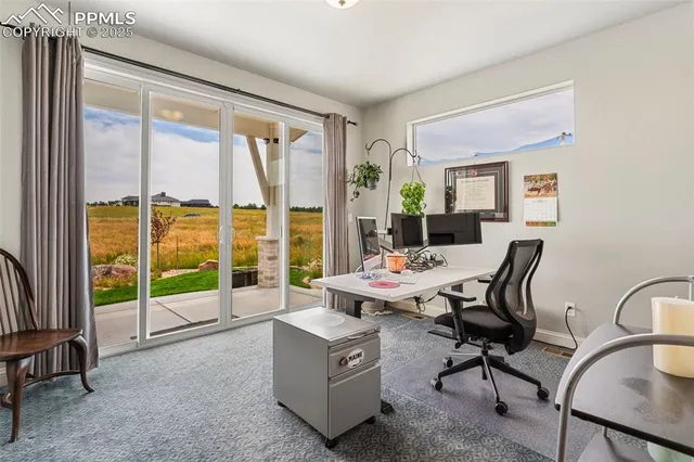 a living room with furniture and floor to ceiling windows