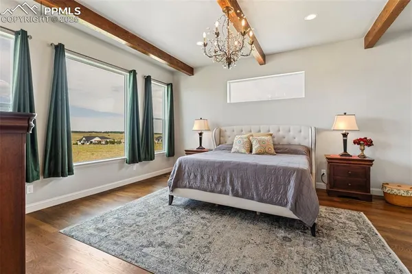 a bedroom with a bed table and window