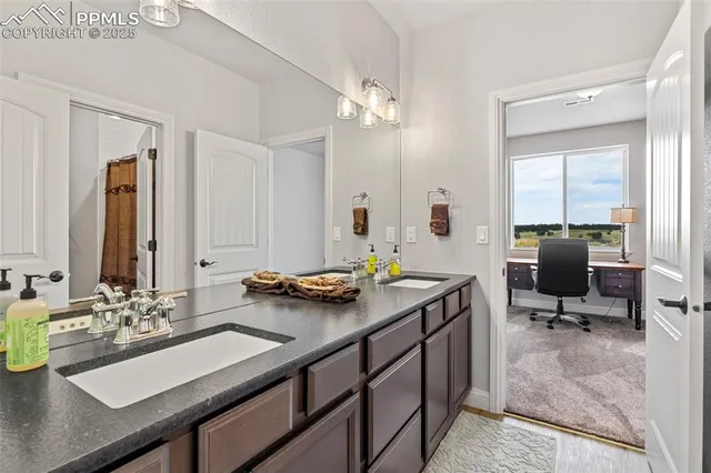 a view of a workspace with furniture and bathroom