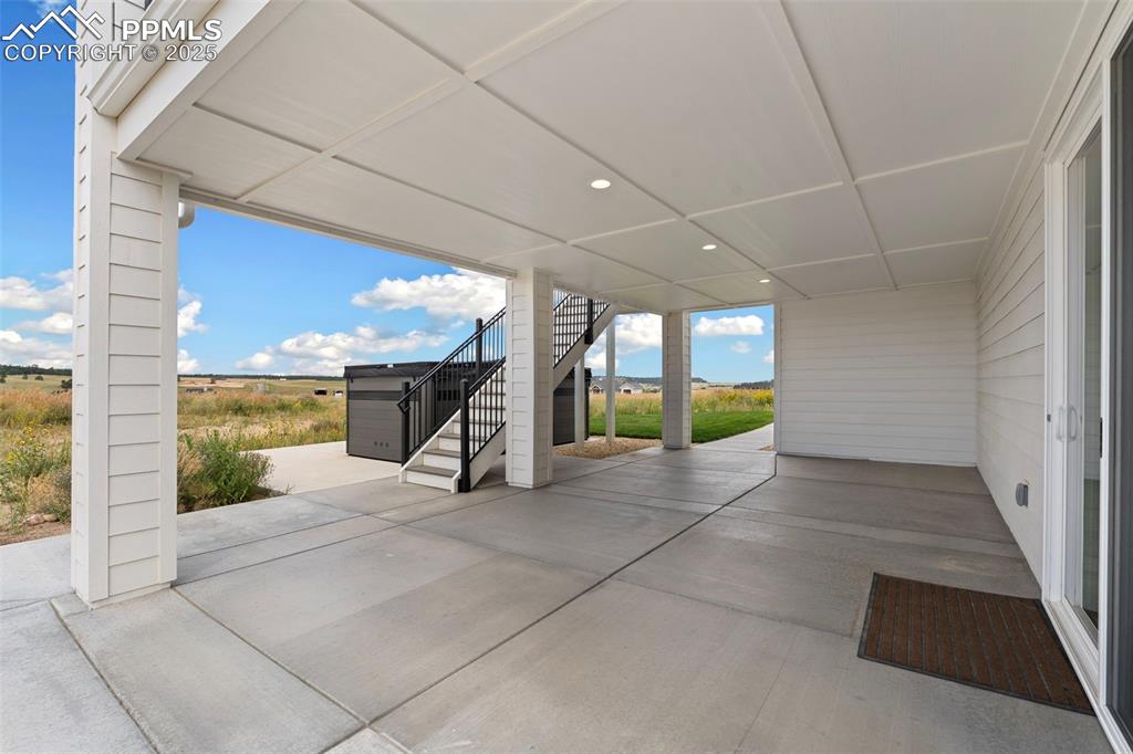 11726 Rambling Road Colorado Springs, CO 80908 - Photo 48 of 50 a view of a hallway with wooden floor and a couch