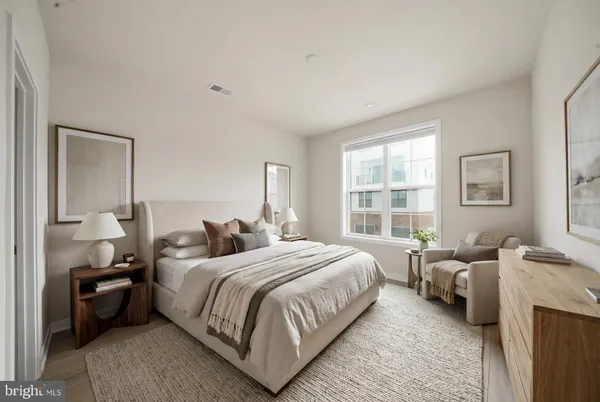 a bedroom with a bed and a couch