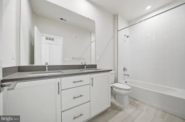 a bathroom with a double vanity sink and a mirror