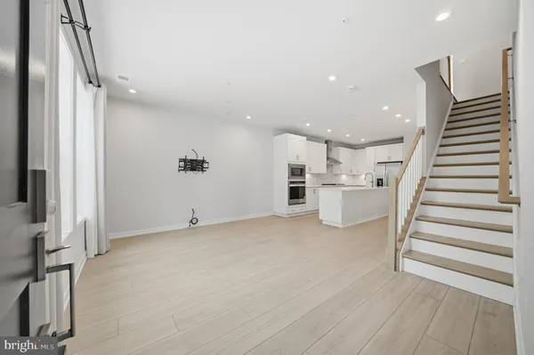 a view of a kitchen with wooden floor and stairs