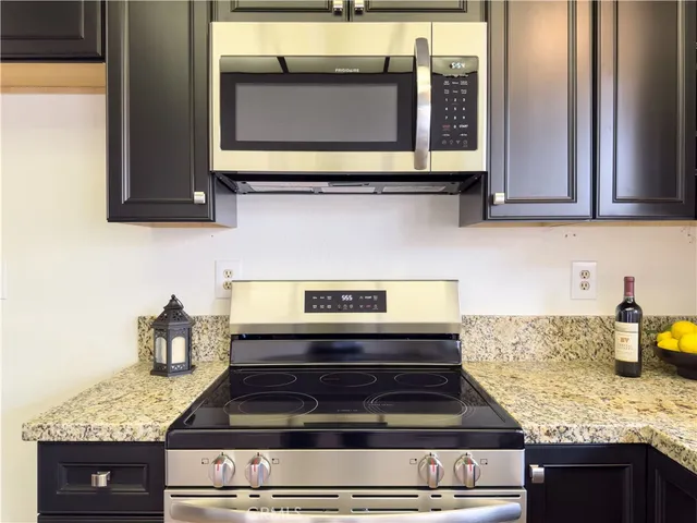 a kitchen with granite countertop cabinets and window