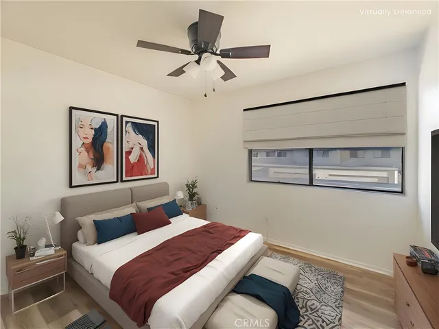 a bedroom with a bed and a painting on the wall