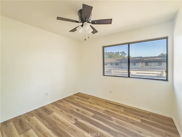 a view of a big room with wooden floor and cabinet