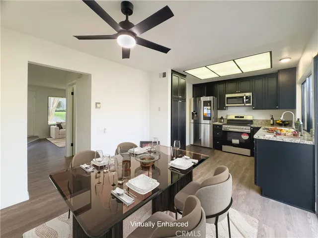 a dining room with furniture and a kitchen view