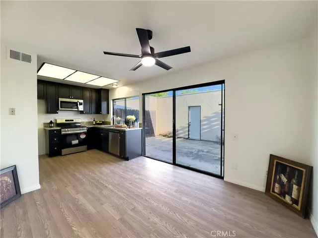 a kitchen with stainless steel appliances kitchen island granite countertop a refrigerator and a stove top oven